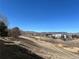 Scenic landscape featuring a path, trees, and building in the distance with mountain views at 519 Wright St # 106, Lakewood, CO 80228