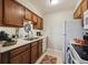 Well-lit kitchen with a convenient layout, modern appliances, and easy access to the dining area, perfect for cooking at 519 Wright St # 106, Lakewood, CO 80228