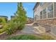 Exterior view of the backyard with patio and a green tree and grass at 15955 E Otero Cir, Centennial, CO 80112