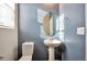 Charming half-bathroom with a pedestal sink, and a round mirror at 15955 E Otero Cir, Centennial, CO 80112