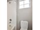 This bathroom has a shower with white tile and a window at 15955 E Otero Cir, Centennial, CO 80112