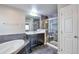 Bathroom featuring a large tub, a walk-in shower, and a double vanity at 15955 E Otero Cir, Centennial, CO 80112