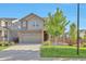 Charming two-story home with a well-manicured lawn, cozy front porch, and attached two-car garage at 15955 E Otero Cir, Centennial, CO 80112