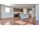 Modern kitchen featuring a central island, stainless steel appliances, dark wood cabinetry, and pendant lighting at 15955 E Otero Cir, Centennial, CO 80112