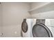 The laundry room has a side-by-side washer and dryer, plus a shelf at 15955 E Otero Cir, Centennial, CO 80112