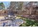A stone patio with a fire pit provides an outdoor entertaining space in the backyard at 1206 E Phillips Pl, Littleton, CO 80122