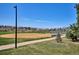 A baseball field next to a paved walking path with mountains in the distance at 1206 E Phillips Pl, Littleton, CO 80122