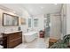 Bright bathroom with a soaking tub, walk-in shower, and modern vanity at 1206 E Phillips Pl, Littleton, CO 80122