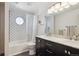 Bathroom featuring black and white tile, shower/tub combination, and modern vanity at 1206 E Phillips Pl, Littleton, CO 80122