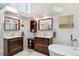 Bright bathroom features dual vanities, soaking tub, linen closet, and neutral tones at 1206 E Phillips Pl, Littleton, CO 80122