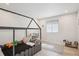 Bright bedroom features a playful bed frame, neutral tones, and laminate wood floors at 1206 E Phillips Pl, Littleton, CO 80122