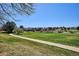 Expansive green space with a paved walking path and distant buildings at 1206 E Phillips Pl, Littleton, CO 80122