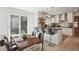 Modern kitchen with stainless steel appliances, breakfast bar, and view to the backyard at 1206 E Phillips Pl, Littleton, CO 80122