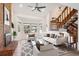 Bright living room features a brick fireplace, a bay window, and staircase at 1206 E Phillips Pl, Littleton, CO 80122