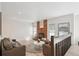 Living room with a brick fireplace, recessed lights, and access to the backyard at 1206 E Phillips Pl, Littleton, CO 80122