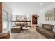 Inviting living room with wood floors and views to the kitchen and staircase at 1206 E Phillips Pl, Littleton, CO 80122