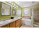 Well-lit bathroom with double sinks, a soaking tub, and a tiled glass-enclosed shower at 9808 E Carolina Pl, Aurora, CO 80247