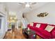 Open-concept living room with hardwood floors, comfortable seating, and stairway access at 9808 E Carolina Pl, Aurora, CO 80247