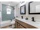 This bathroom has wood cabinets, double sinks, white countertops, and a tiled shower at 116 S 10Th Ave, Brighton, CO 80601