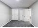 This bedroom features soft gray walls, plush gray carpet, and bright white closets at 116 S 10Th Ave, Brighton, CO 80601