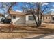 Side view of single-story house with stone accents and manicured yard at 116 S 10Th Ave, Brighton, CO 80601