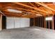 The garage is spacious with a concrete floor and a white door at 116 S 10Th Ave, Brighton, CO 80601