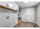 Mud room with white cabinets, wooden bench, and wood-look vinyl flooring at 116 S 10Th Ave, Brighton, CO 80601