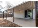 A covered patio with a sliding glass door. The exterior is a light color at 116 S 10Th Ave, Brighton, CO 80601