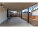 A covered patio with a view of a wooden fence and a hot tub in the backyard at 116 S 10Th Ave, Brighton, CO 80601