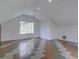 Finished attic space features unique flooring, recessed lighting, and a window bringing in natural light at 5072 Meadow Mountain Dr, Broomfield, CO 80023