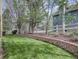 Beautiful backyard with a brick retaining wall and green grass with other homes visible in the distance at 5072 Meadow Mountain Dr, Broomfield, CO 80023