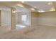Finished basement with neutral carpet, painted columns and a window bringing in natural light at 5072 Meadow Mountain Dr, Broomfield, CO 80023