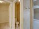 Bathroom featuring a water closet, a light neutral wall, and a bright light at 5072 Meadow Mountain Dr, Broomfield, CO 80023