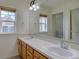 Bright bathroom with dual sinks and a large mirror, creating a spacious and functional area at 5072 Meadow Mountain Dr, Broomfield, CO 80023