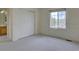 Bright bedroom features neutral carpet, closet, and a window with a view of the outdoors at 5072 Meadow Mountain Dr, Broomfield, CO 80023
