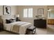 Well-lit primary bedroom featuring a queen size bed, shuttered window and modern furnishings at 5072 Meadow Mountain Dr, Broomfield, CO 80023