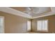 Spacious bedroom featuring a tray ceiling with a ceiling fan and a window to let in natural light at 5072 Meadow Mountain Dr, Broomfield, CO 80023