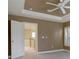 Bedroom with neutral walls, tray ceiling, a ceiling fan, and bright natural light at 5072 Meadow Mountain Dr, Broomfield, CO 80023