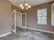 Cozy dining area features tiled floors, a chandelier, and French doors at 5072 Meadow Mountain Dr, Broomfield, CO 80023