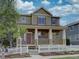 Beautiful two-story home featuring a welcoming front porch and a classic white picket fence at 5072 Meadow Mountain Dr, Broomfield, CO 80023
