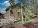 Exterior of home with siding and a second story deck and stairway surrounded by trees and green space at 5072 Meadow Mountain Dr, Broomfield, CO 80023
