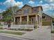 Inviting two-story home with a spacious front porch, attached garage, and manicured lawn at 5072 Meadow Mountain Dr, Broomfield, CO 80023
