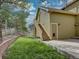 Exterior of home showing the backyard, a grassy area, a retaining wall, and stairs to an upper level at 5072 Meadow Mountain Dr, Broomfield, CO 80023