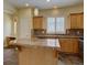 Bright kitchen featuring granite countertops, oak cabinets, and stainless steel appliances at 5072 Meadow Mountain Dr, Broomfield, CO 80023