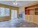 Living room with slate tile flooring, built-in shelving, and sliding glass doors to the exterior at 5072 Meadow Mountain Dr, Broomfield, CO 80023