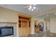 Open-concept area showcases a fireplace, built-in shelves, and a view into the kitchen at 5072 Meadow Mountain Dr, Broomfield, CO 80023