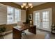 Well-lit home office with a large window and French doors, creating an inviting and productive workspace at 5072 Meadow Mountain Dr, Broomfield, CO 80023