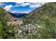 High-angle view of a mountain town nestled among green hills and blue skies at 2152 Bighorn Rd # 203, Georgetown, CO 80444