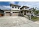 Inviting two-story home featuring a three-car garage, stone accents, and a covered front porch at 4609 Thistle Dr, Brighton, CO 80601