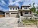 Inviting two-story home featuring a three-car garage, stone accents, and a covered front porch at 4609 Thistle Dr, Brighton, CO 80601